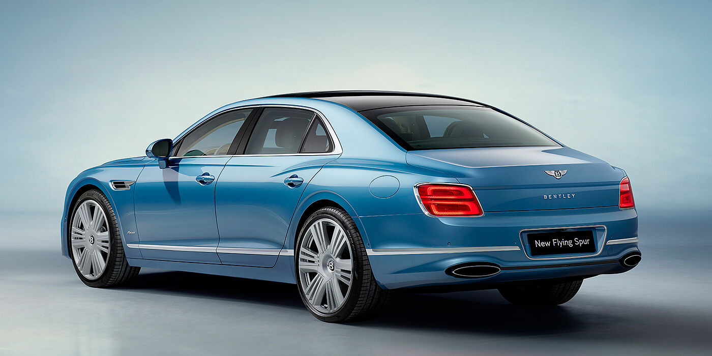 Bentley St Peter New Bentley Flying Spur Azure sedan rear view in Light windsor blue by Mulliner paint with 22 inch Azure wheels and chrome exterior details