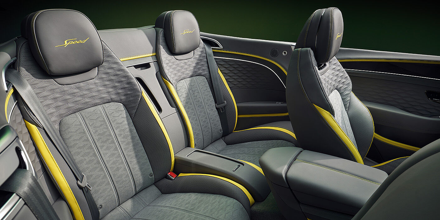 Bentley St Peter Bentley New Continental GTC Speed convertible rear interior with unique Speed colour split in Gravity Grey and Cyber Yellow hide colours, and contrast stitched headrest emblems 