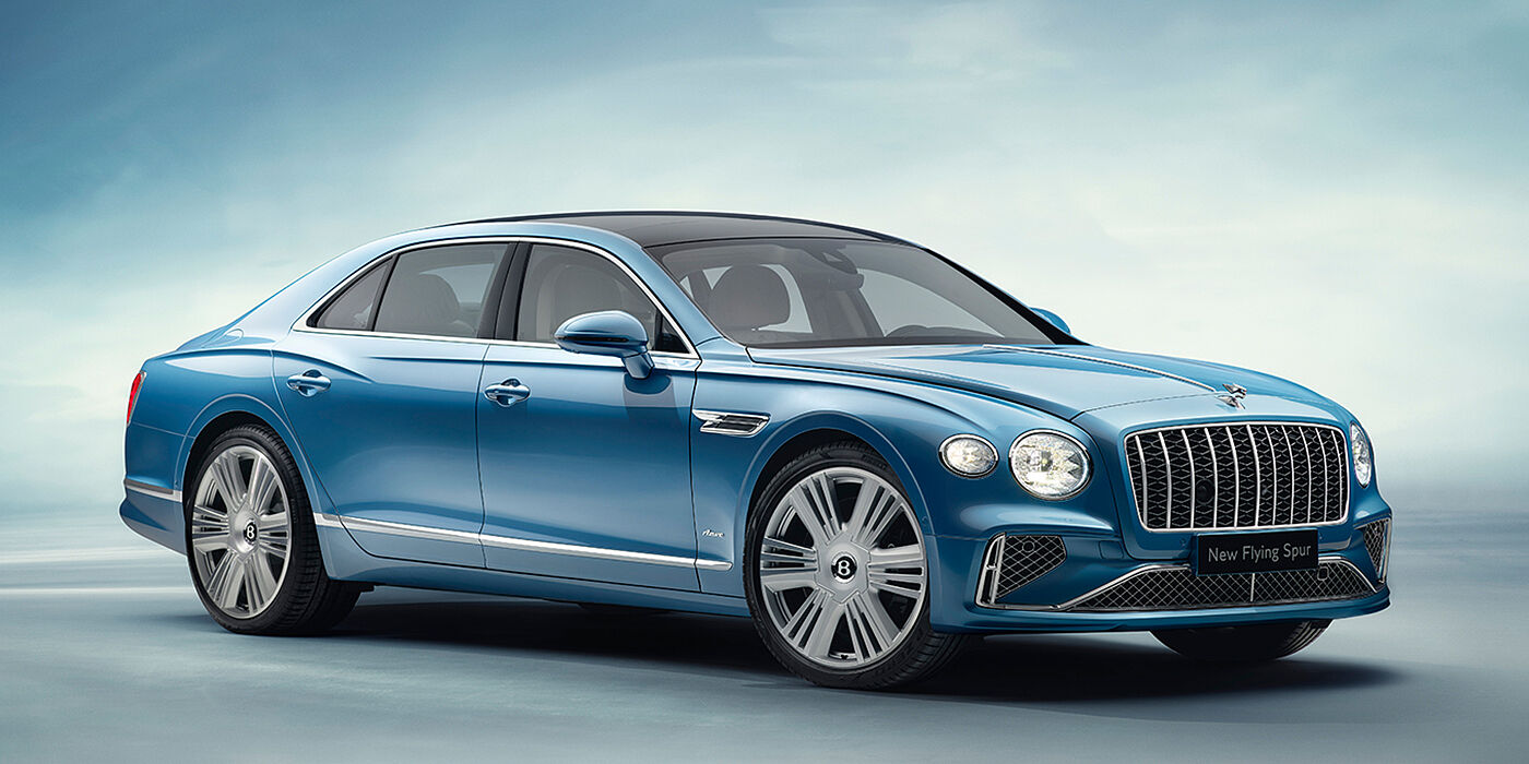 Bentley St Peter New Bentley Flying Spur Azure sedan front view in Light windsor blue by Mulliner paint with 22 inch Azure wheels and chrome exterior details