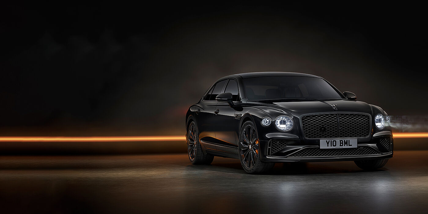 Bentley St Peter Bentley Flying Spur Black Edition sedan in Black Crystal paint against a dark grey and copper coloured background