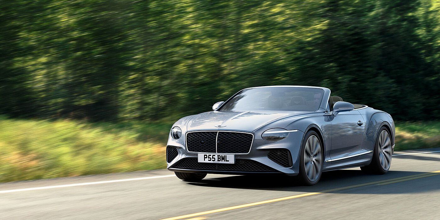 Bentley St Peter New Bentley Continental GTC convertible front view in Silverlake paint with 22 inch ten spoke wheels, driving dynamically on a country road