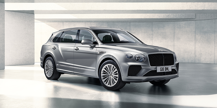 Bentley St Peter Bentley Bentayga Extended Wheelbase SUV front three quarter in Moonbeam paint with a grey background