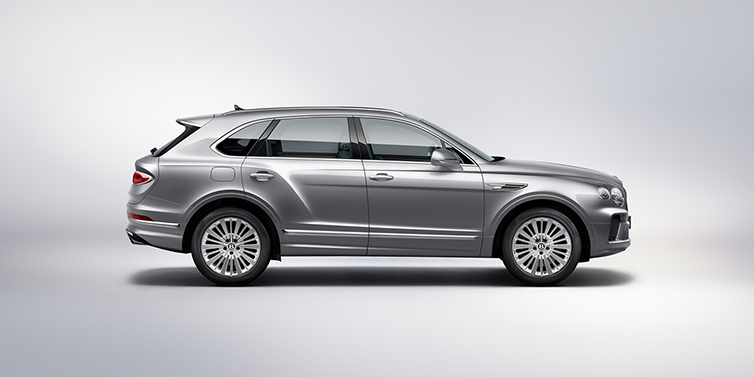 Bentley St Peter Bentley Bentayga SUV side profile in Moonbeam silver paint against white background featuring 21 inch 5 spoke wheels