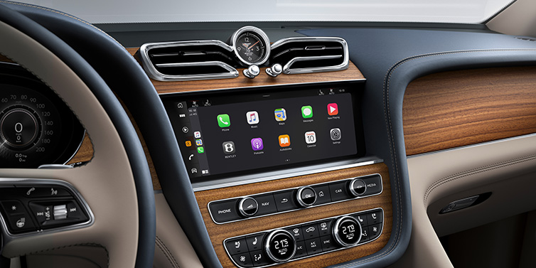 Bentley St Peter Bentley Bentayga Extended Wheelbase Azure SUV front interior centre console with MMI screen showing apps, surrounded by Portland and Imperial Blue coloured hides